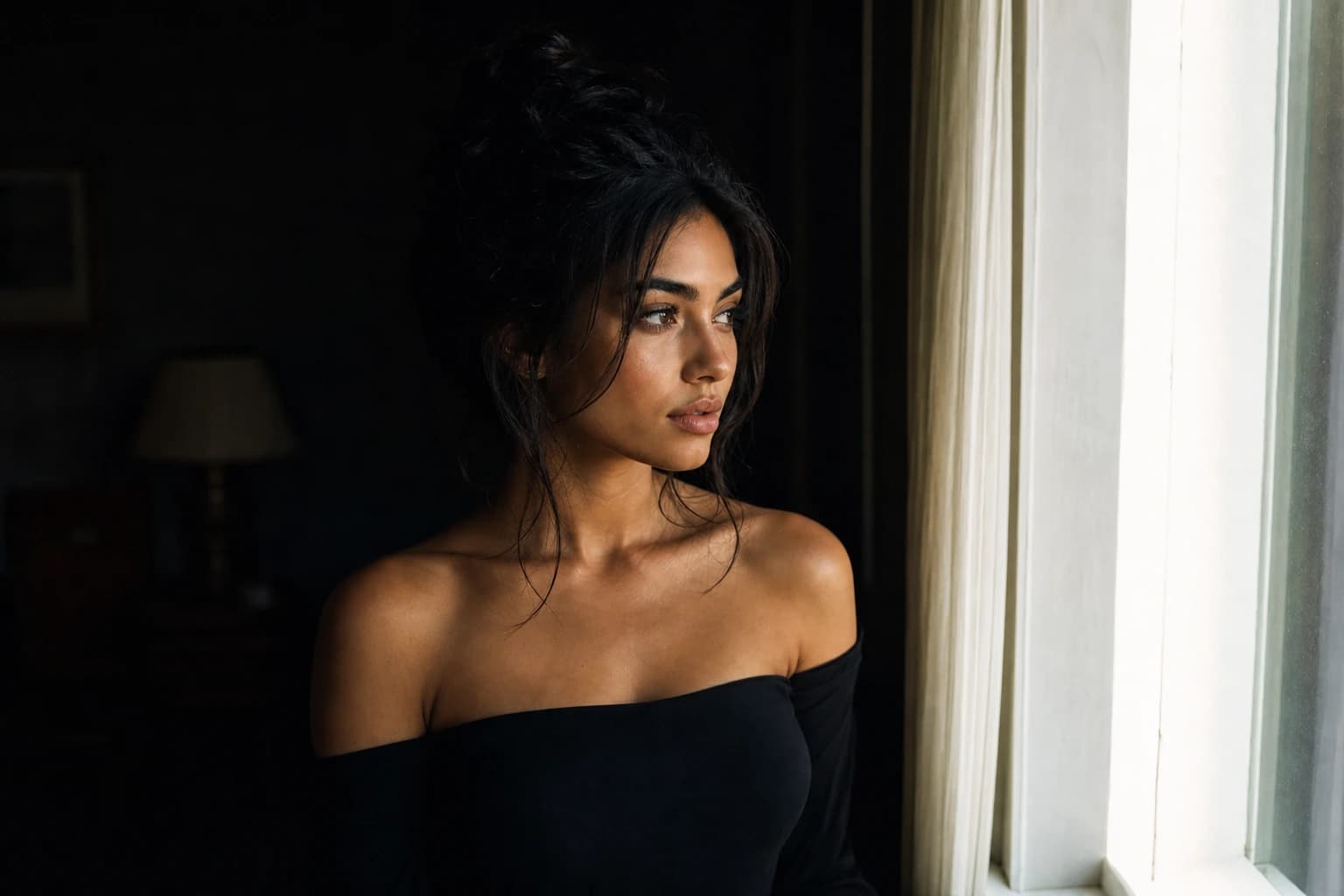AI-generated image of a dark-haired woman in a black off-shoulder dress standing in a dim room, turned toward a bright window: deep shadows behind her, rich midtones across her skin, and the sunlit window edge approaching pure white.